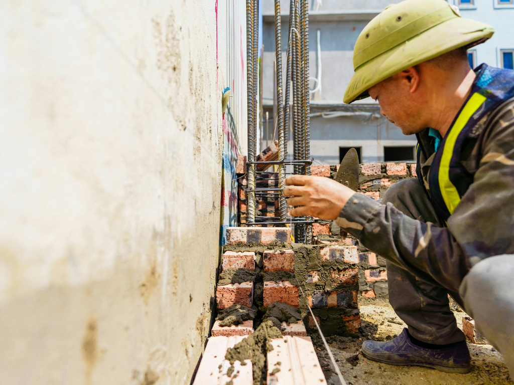 What causes concrete spalling on Singapore facades?